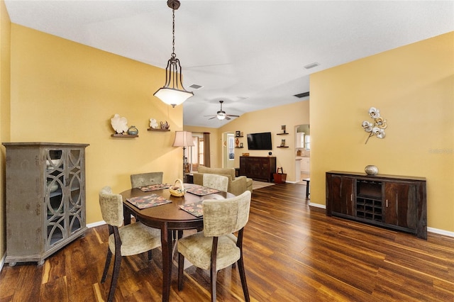 dining room with ceiling fan, lofted ceiling, and dark hardwood / wood-style flooring