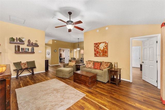 living room featuring dark wood-type flooring, vaulted ceiling, and ceiling fan