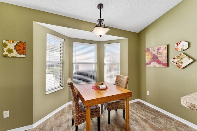 dining space featuring a textured ceiling