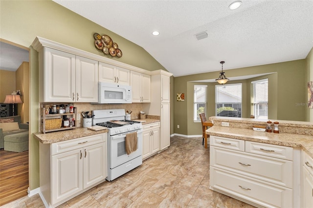 kitchen with vaulted ceiling, pendant lighting, white cabinets, and white appliances