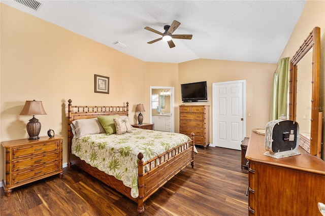 bedroom featuring vaulted ceiling, dark hardwood / wood-style floors, ceiling fan, and ensuite bathroom