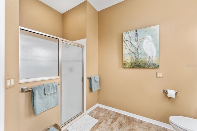 bathroom featuring toilet and walk in shower