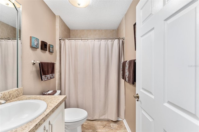 bathroom featuring vanity, walk in shower, a textured ceiling, and toilet