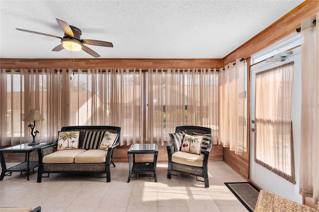 sunroom featuring ceiling fan