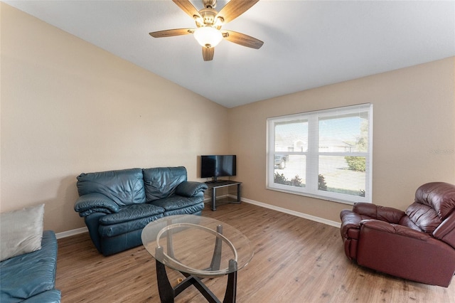 living room featuring ceiling fan, lofted ceiling, and light wood-type flooring