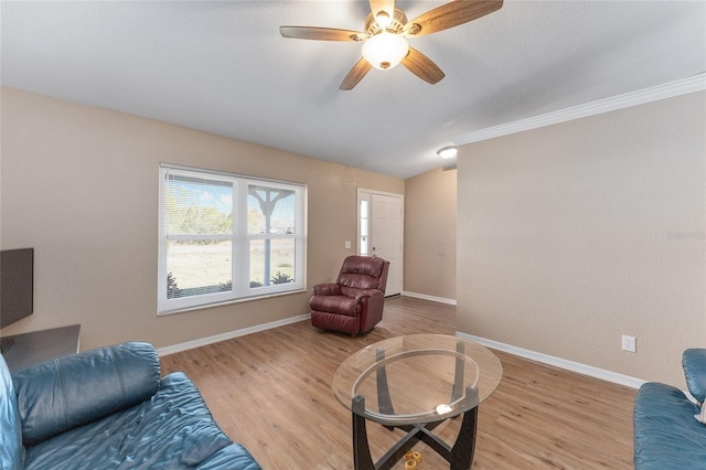 interior space featuring crown molding, ceiling fan, vaulted ceiling, and light wood-type flooring