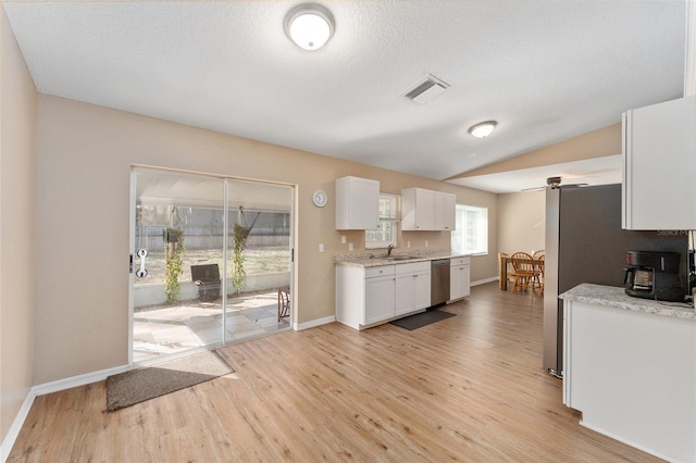 kitchen with lofted ceiling, sink, dishwasher, light hardwood / wood-style floors, and white cabinets