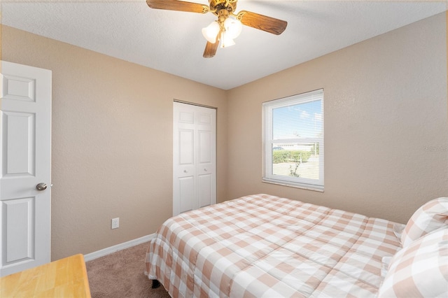 bedroom featuring ceiling fan, a closet, and carpet