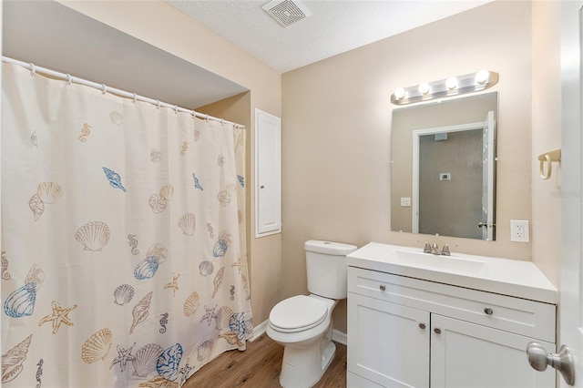 bathroom featuring toilet, a textured ceiling, vanity, a shower with shower curtain, and hardwood / wood-style flooring