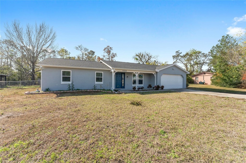 ranch-style house featuring a garage and a front yard