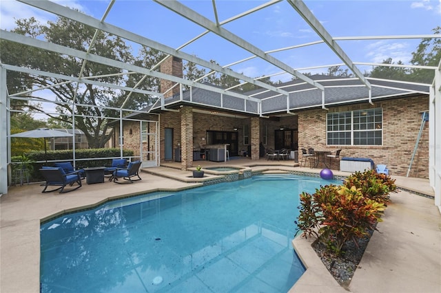 view of swimming pool featuring an in ground hot tub, a lanai, and a patio area