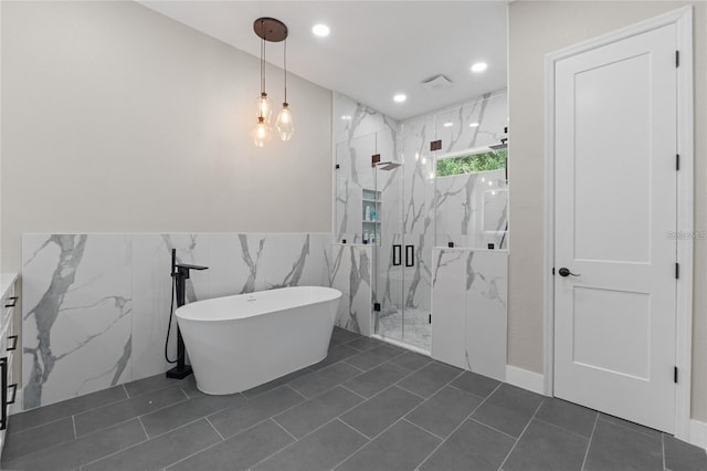 bathroom featuring shower with separate bathtub, tile walls, and tile patterned floors