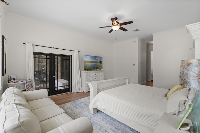 bedroom with crown molding, access to outside, hardwood / wood-style floors, and french doors