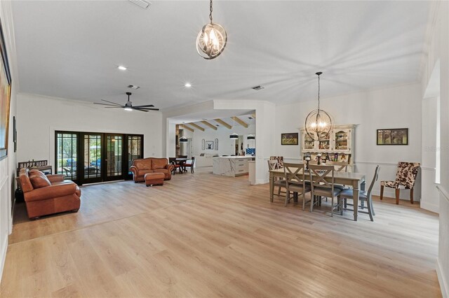 dining room with french doors, ceiling fan with notable chandelier, and light wood-type flooring