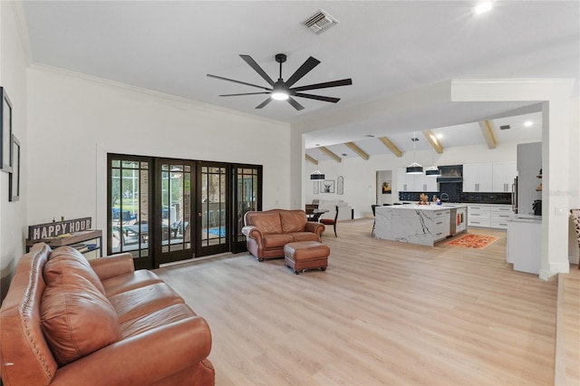 living room featuring lofted ceiling with beams, sink, ceiling fan, light hardwood / wood-style floors, and french doors