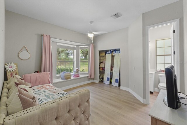 bedroom featuring ensuite bathroom, ceiling fan, and light hardwood / wood-style floors