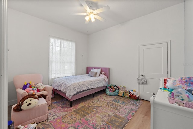 bedroom with ceiling fan and light wood-type flooring