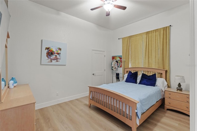 bedroom with ceiling fan and light hardwood / wood-style floors