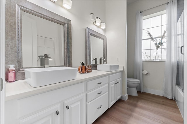 full bathroom featuring shower / bath combo with shower curtain, vanity, toilet, and wood-type flooring