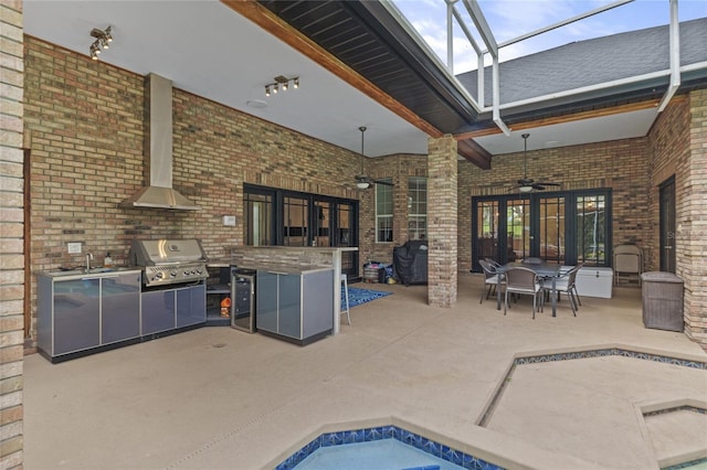 view of pool featuring area for grilling, a skylight, a hot tub, and ceiling fan