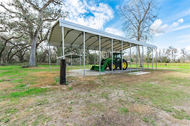 view of parking / parking lot featuring a lawn and a carport