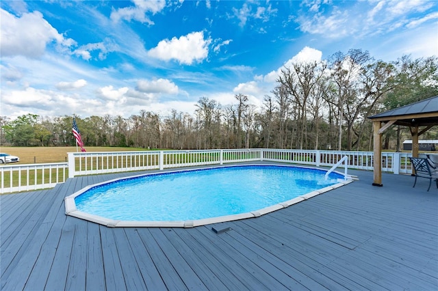 view of pool featuring a wooden deck and a gazebo