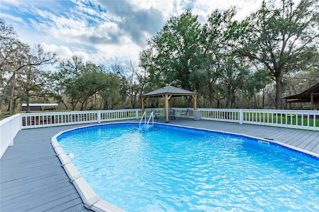 view of pool with a gazebo and a wooden deck