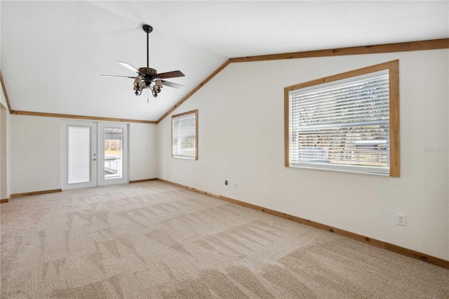 empty room with french doors, ceiling fan, vaulted ceiling, and light carpet