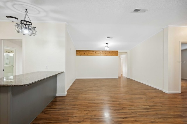 interior space with ornamental molding, dark hardwood / wood-style flooring, and a chandelier