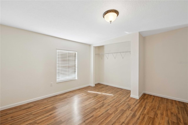 empty room with hardwood / wood-style flooring