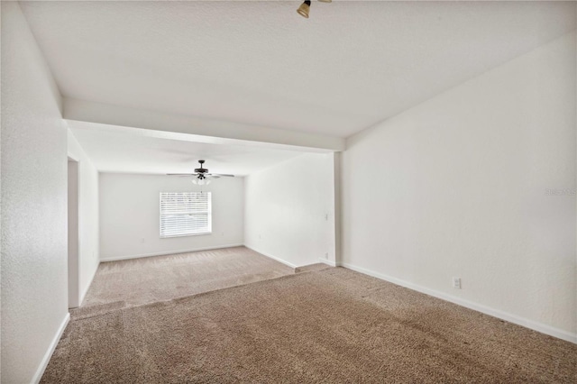 empty room featuring carpet floors and ceiling fan