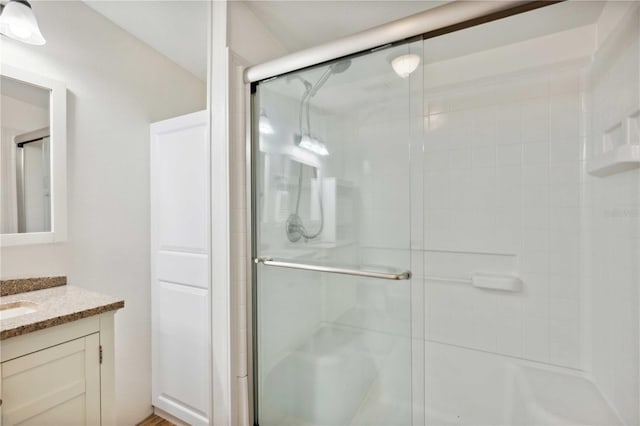 bathroom with an enclosed shower and vanity