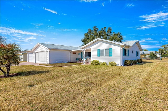 ranch-style home with a garage and a front lawn