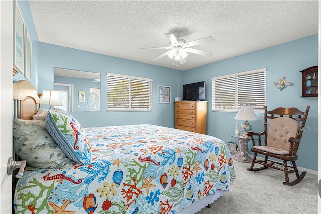 carpeted bedroom with a textured ceiling and ceiling fan