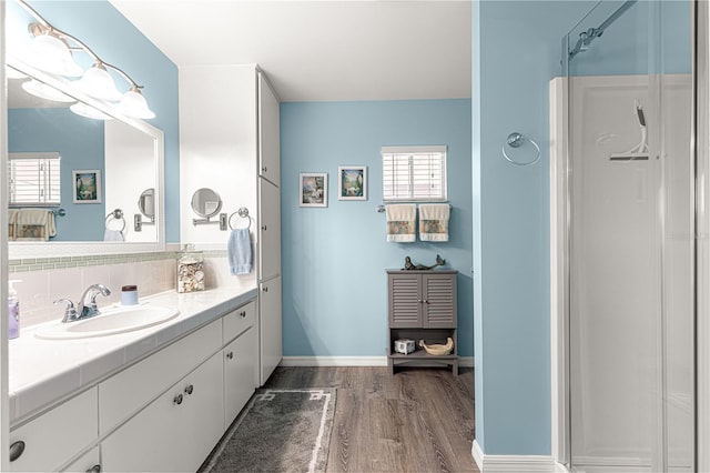 bathroom with vanity, hardwood / wood-style floors, and a shower