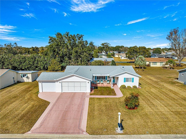 ranch-style house featuring a garage and a front yard