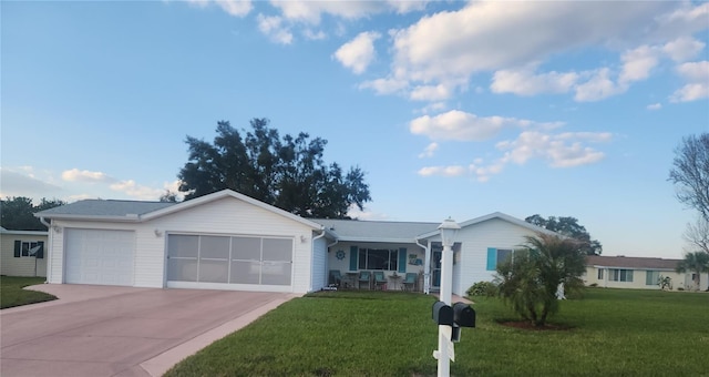 ranch-style home with a garage, driveway, and a front lawn