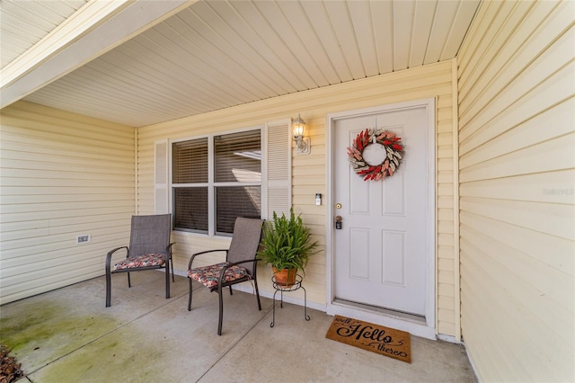 view of exterior entry with a porch
