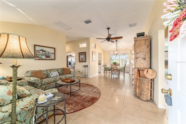 tiled living room with ceiling fan and vaulted ceiling