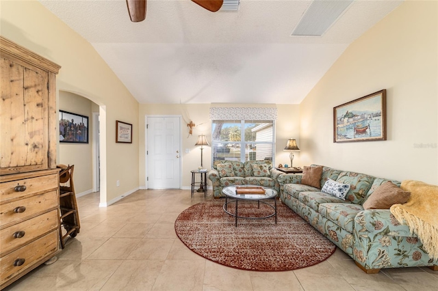 living room with vaulted ceiling, ceiling fan, and light tile patterned flooring