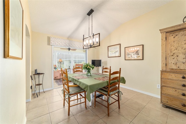 dining room with light tile patterned floors, vaulted ceiling, a textured ceiling, and ceiling fan