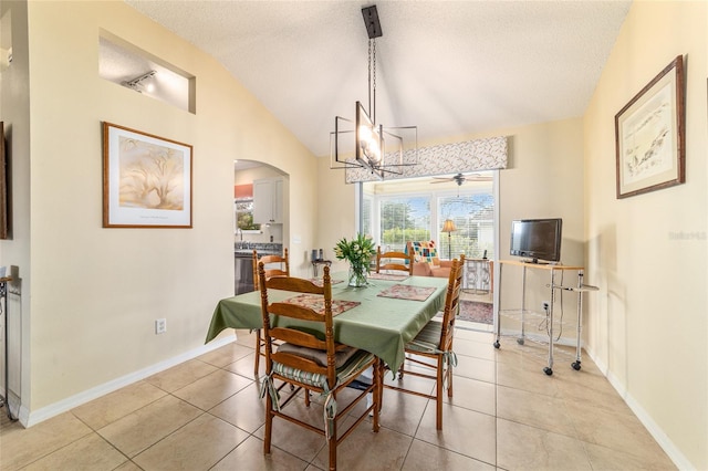dining room featuring vaulted ceiling, a chandelier, light tile patterned flooring, and a textured ceiling