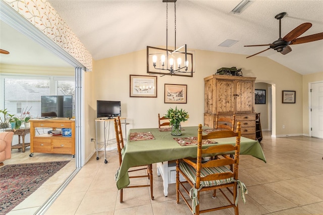 tiled dining room with lofted ceiling, a textured ceiling, and ceiling fan
