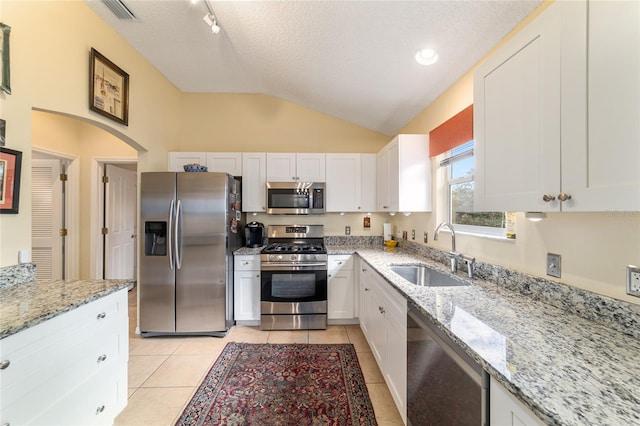 kitchen featuring appliances with stainless steel finishes, sink, and white cabinets
