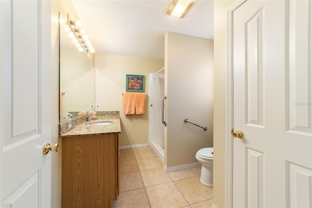 bathroom featuring vanity, a textured ceiling, tile patterned floors, toilet, and walk in shower