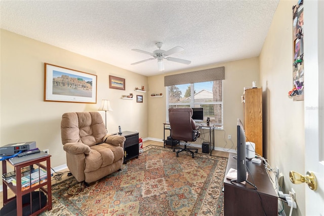 office with ceiling fan, hardwood / wood-style flooring, and a textured ceiling
