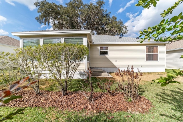 rear view of property with a yard