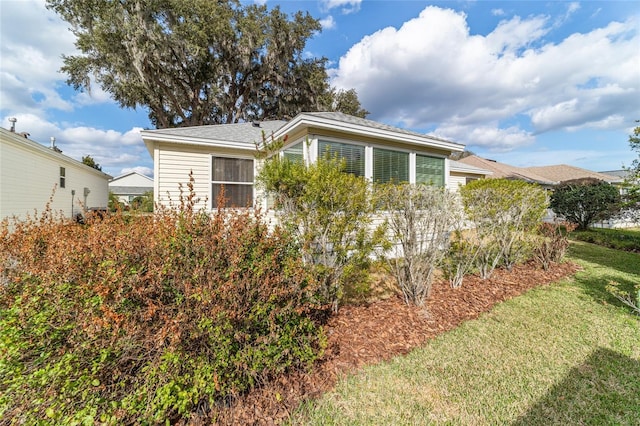 view of side of home featuring a lawn