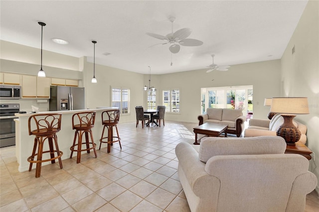 tiled living room featuring ceiling fan