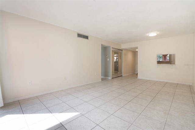 unfurnished room with light tile patterned floors